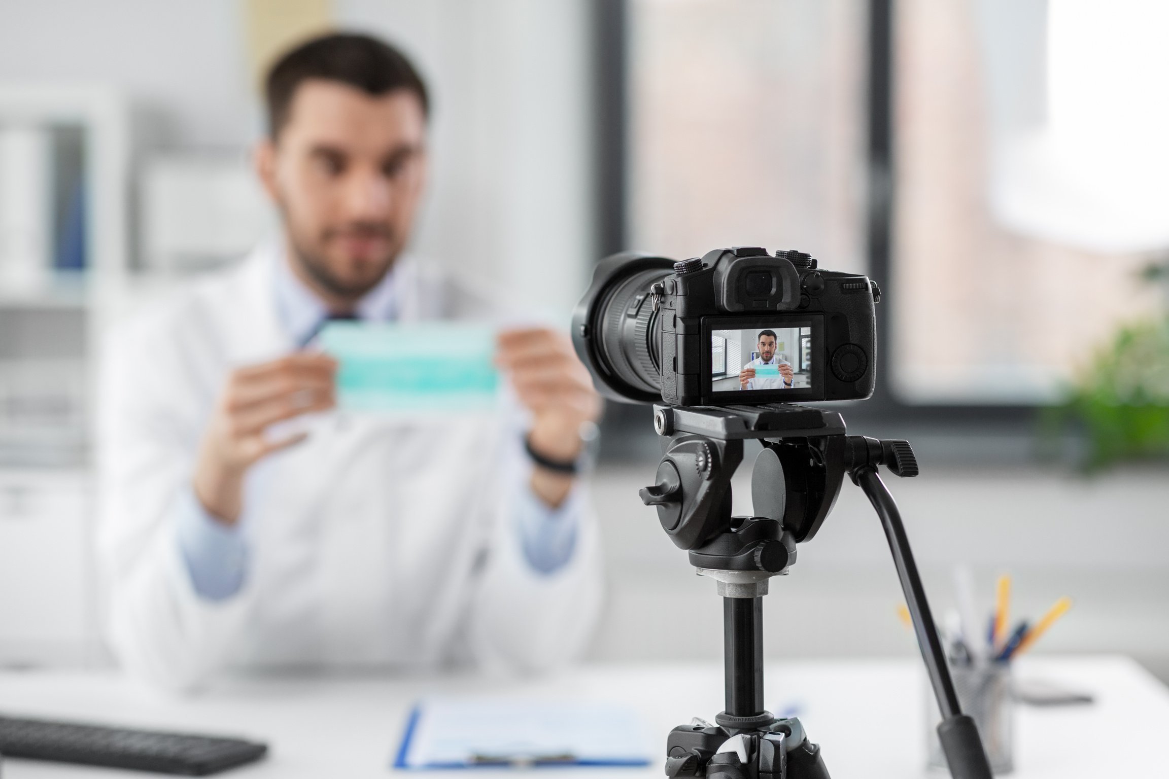 Doctor with Mask Recording Video Blog at Hospital